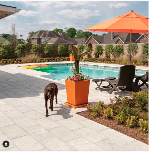 Combine Brightly Colored Pots and Pool Accessories With More Earthy and Neutral-toned Pavers.