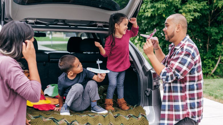 Latino family of four playing outside. Estate planning helps protect what you value the most.