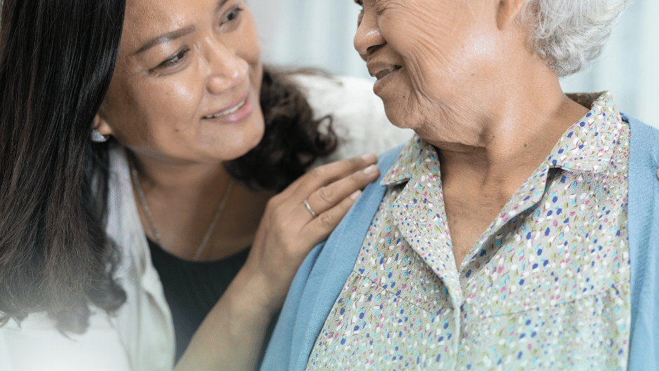 An asian woman and and elderly asian woman sharing a moment together