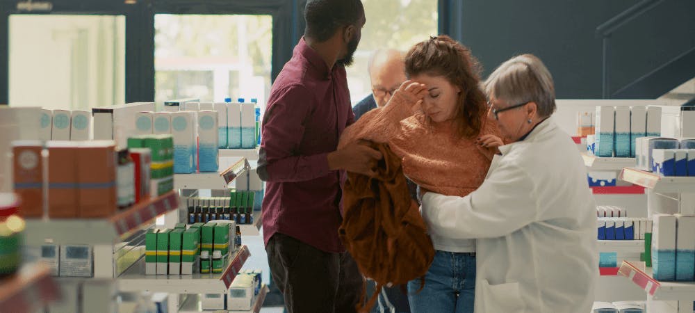 Woman being helped up after a fall in a store