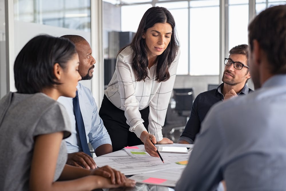 Woman pointing to some documents during a meeting