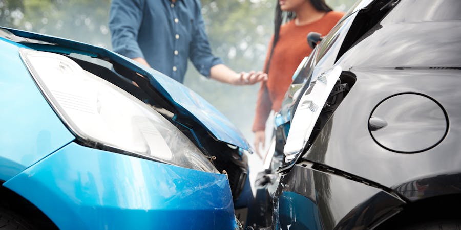 a man and woman arguing after a rear end accident