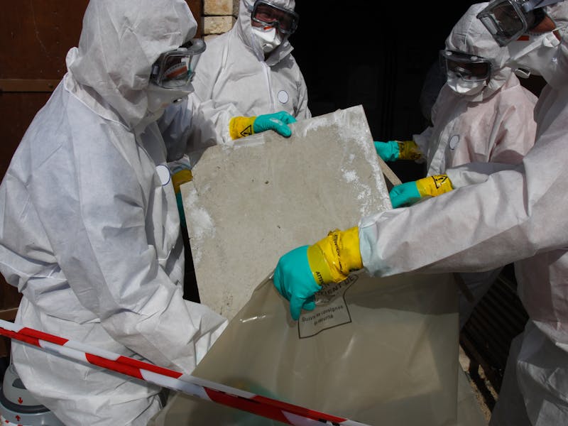 health workers removing toxic materials from a workplace