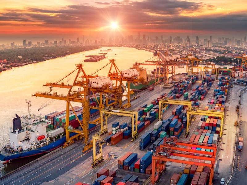 Cargo ship yard with a sunset in the background