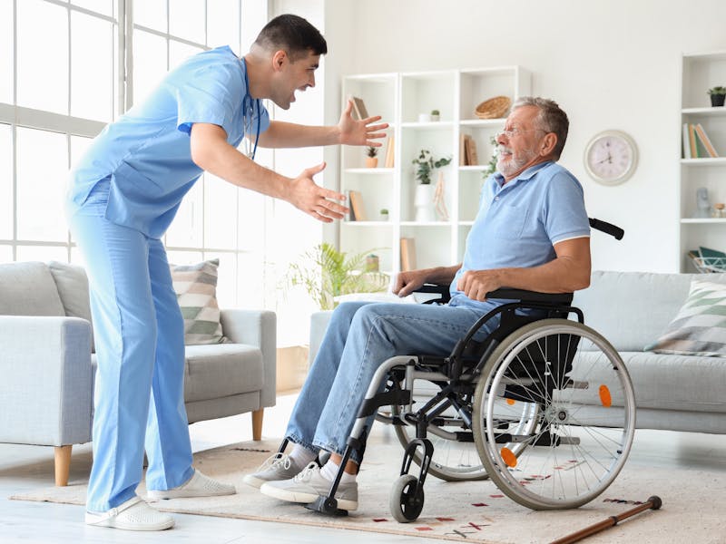 Nursing home employee yelling at elderly resident in wheelchair 