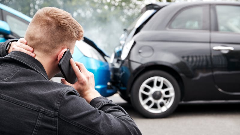 Man on a phone call with his lawyers after a car accident