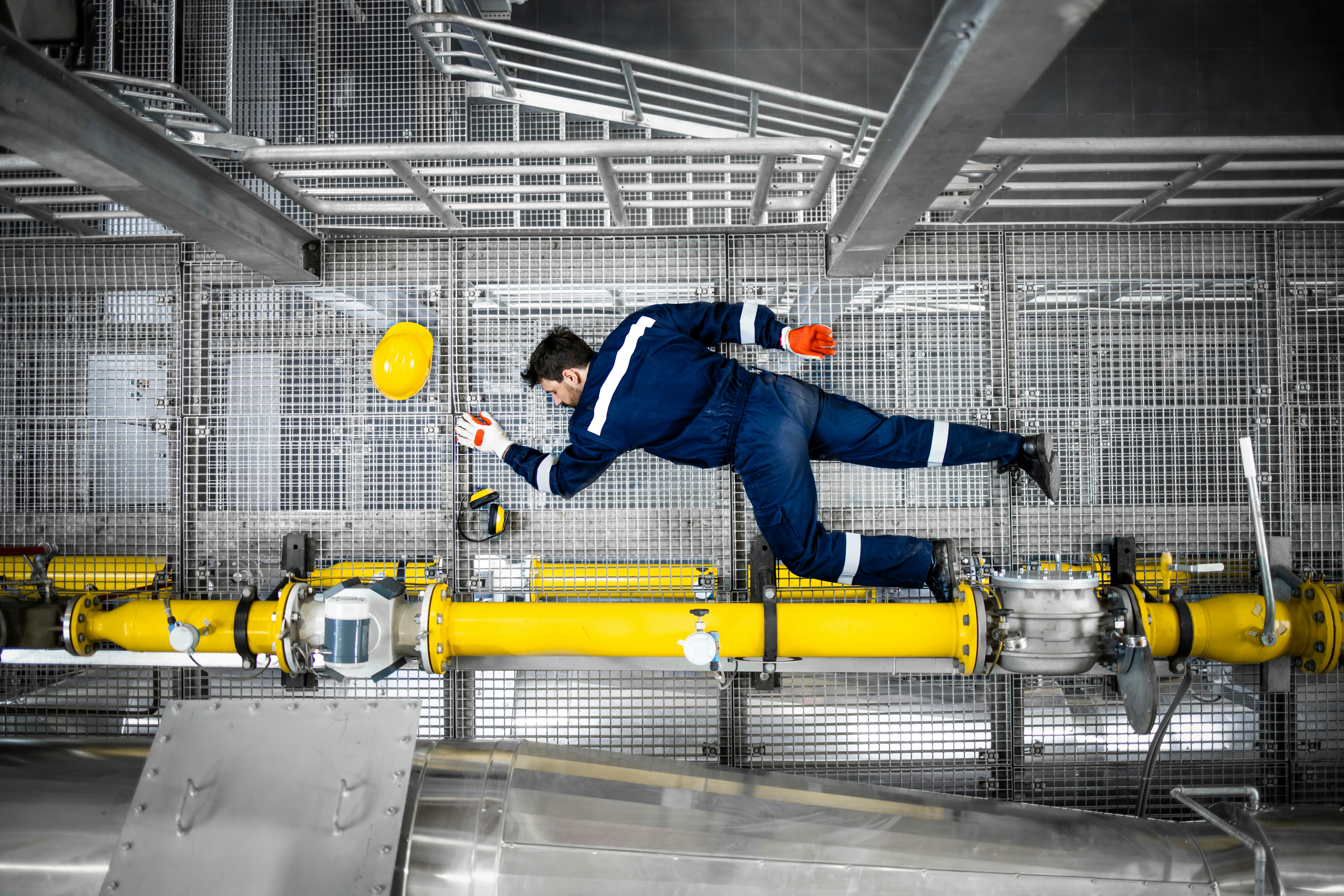 man laying on factory floor due to injury