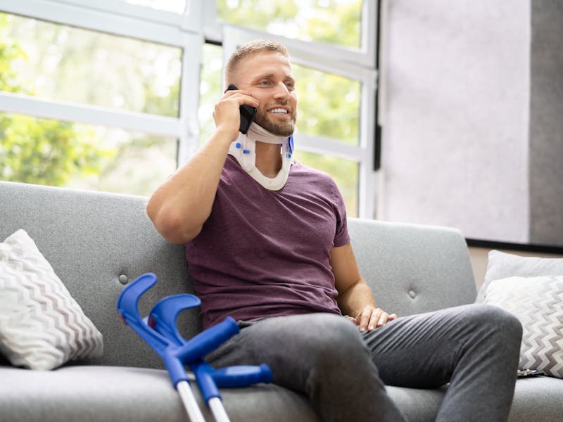 neck injury patient on the phone with his lawyer after suffering a workplace injury