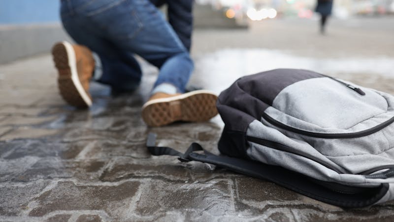 Student on the floor of the school hallway after slipping and falling