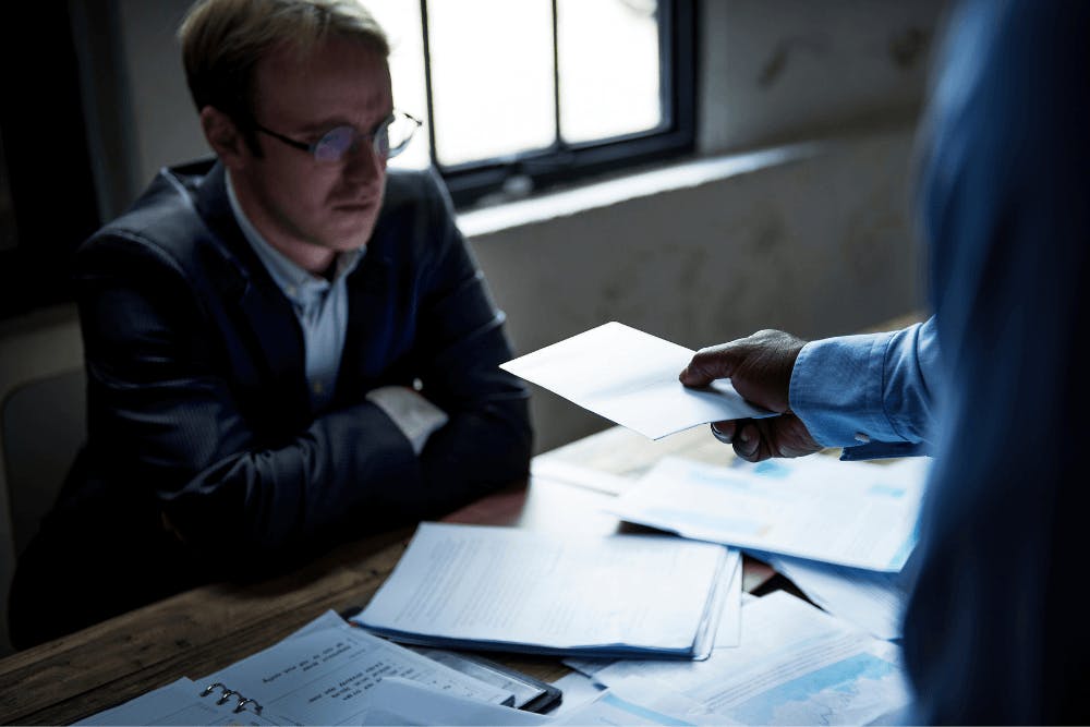 man being handed a document